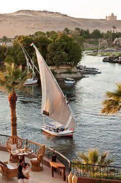 A felucca under full sail on the tranquil Nile at Aswan